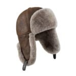 Brown shearling leather trapper hat with soft fur lining, warm winter aviator ushanka style