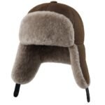 Brown shearling leather trapper hat with soft fur lining, warm winter aviator ushanka style